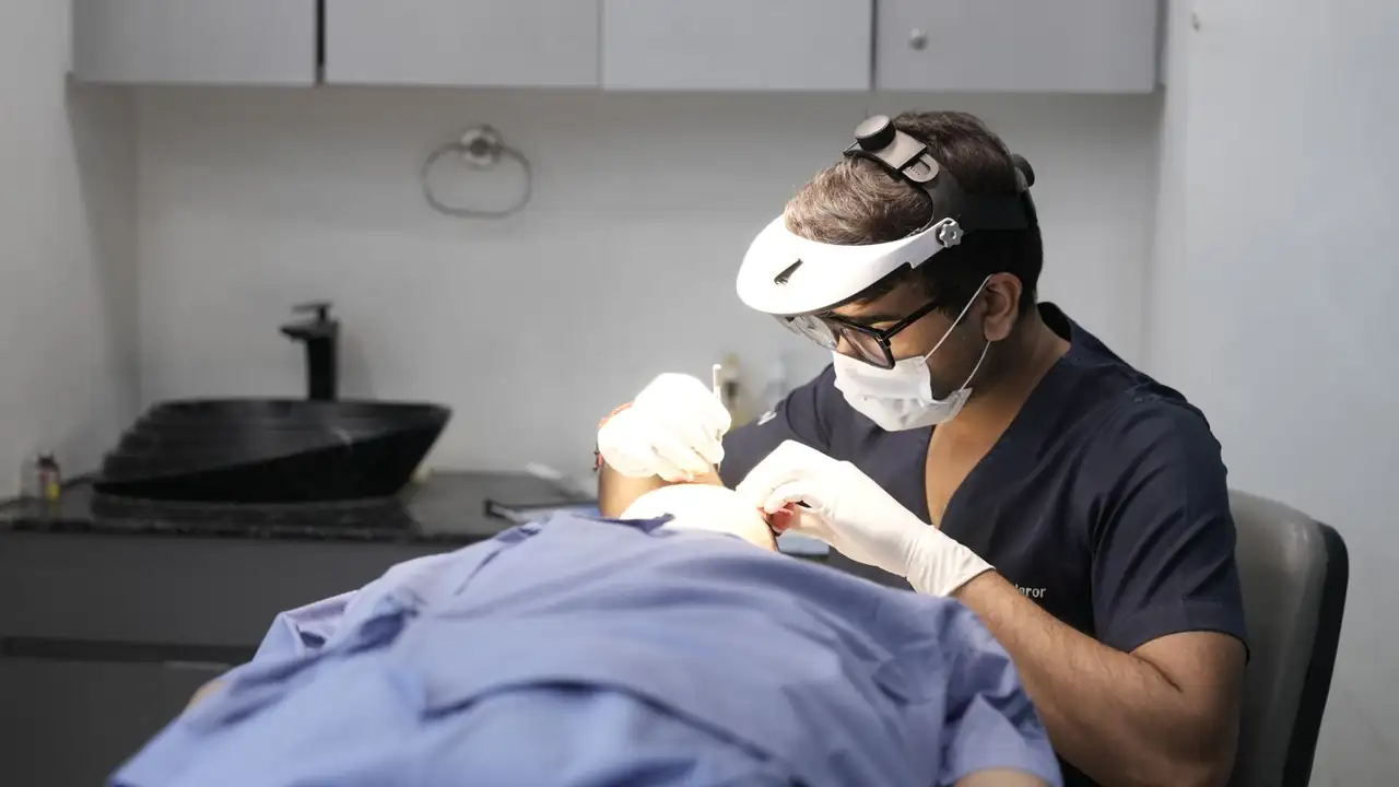A dermatologist conducts a skin treatment on a patient in a modern clinic setting.